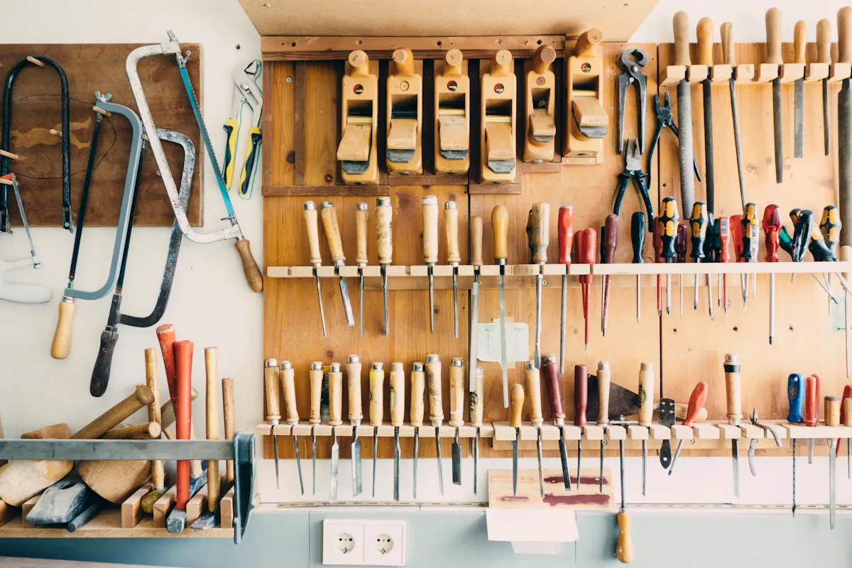 Carpentry tools arranged on wall-mounted storage